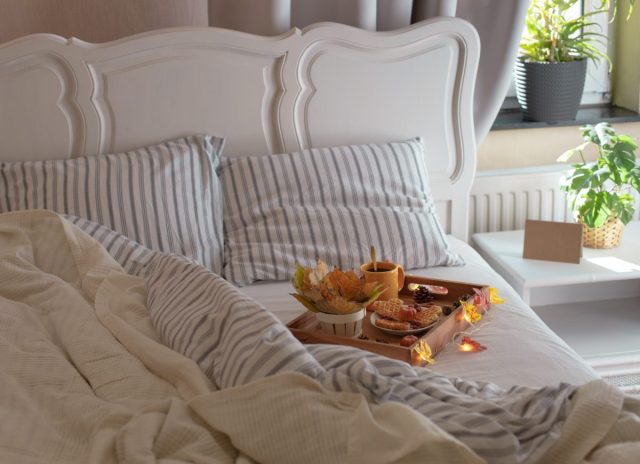 wooden-tray-with-breakfast-and-a-garland-in-bed-2024-08-01-00-02-10-utc